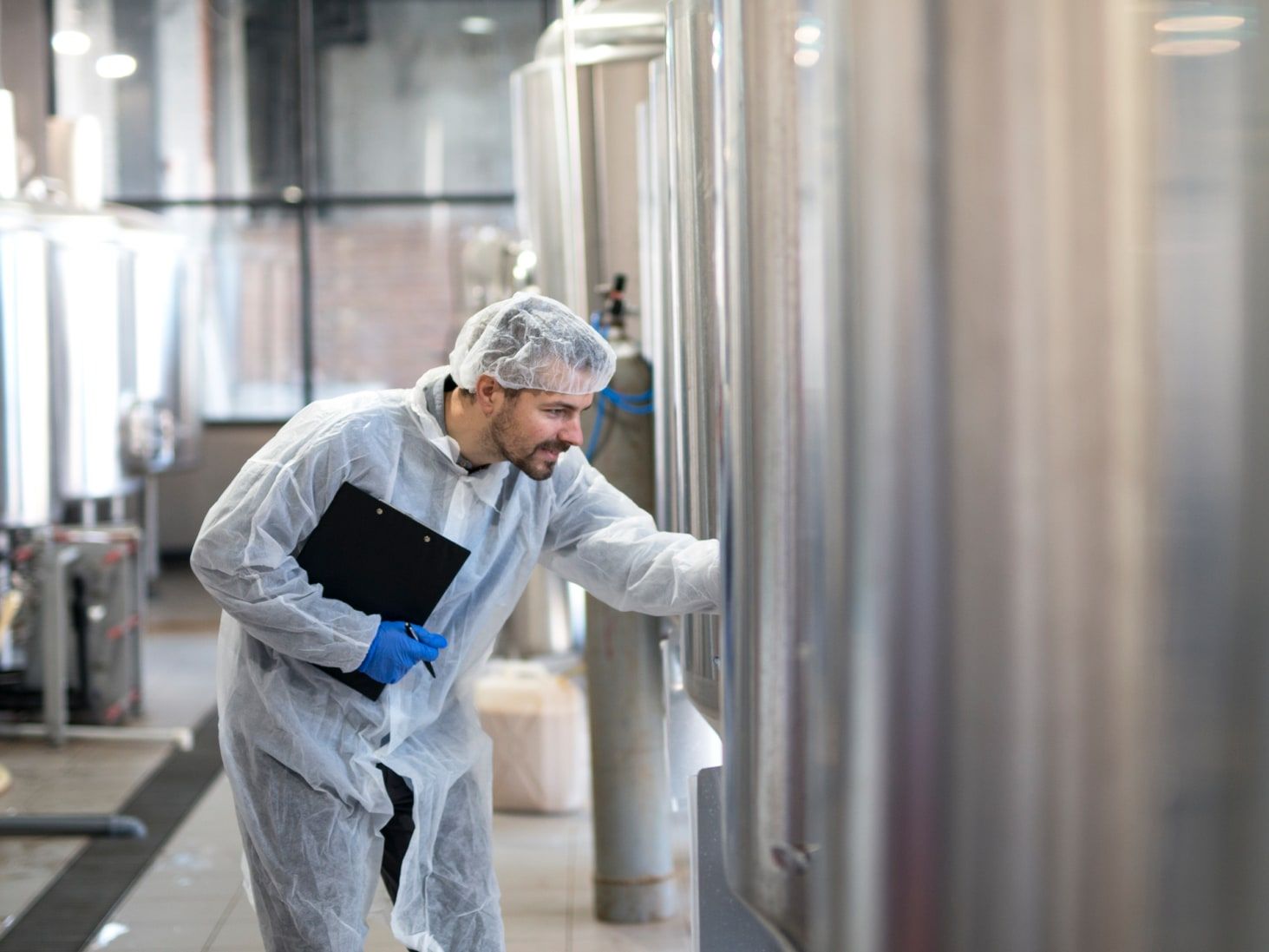 Technologist checking a dairy production line